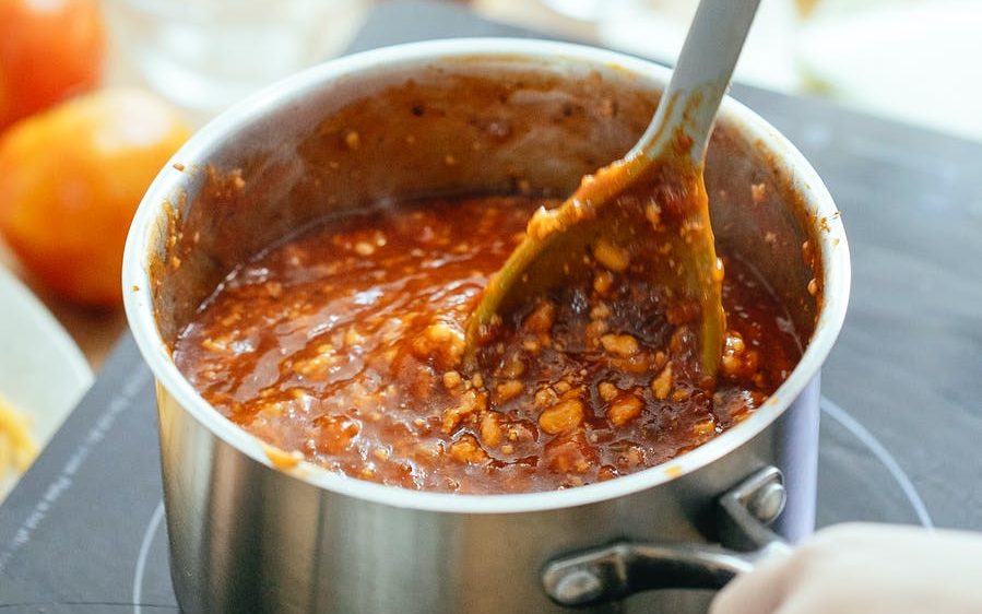 crop person cooking delicious chili